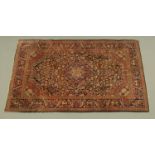 An antique Persian design rug, principal colours red, blue and beige.
