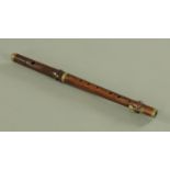 A rosewood piccolo/flute, late 19th / early 20th century, in two sections,