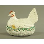 A 19th century Staffordshire hen on nest egg cruet, chick showing, green band to top of nest,