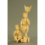 A late 19th/early 20th century Japanese carved ivory figure group, standing and seated male farmers,