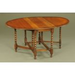 An oak gate legged dining table, oval,