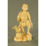 A late 19th/early 20th century Japanese carved ivory figure of a wood cutter and goose,