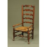 A 19th century ladder back rush seated low chair,