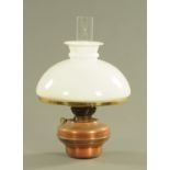 A Victorian brass and copper hanging oil lamp.