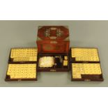 A cased Mahjong set, with twin carrying handles to the plated mounts,
