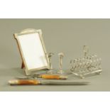 An Art Deco silver plated and mother of pearl effect photograph frame, a toast rack,