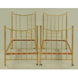 A pair of 19th century brass single beds, each with two ends and side rails. Width 91 cm.