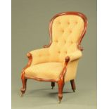 A Victorian mahogany framed gentleman's armchair, with deep buttoned back,