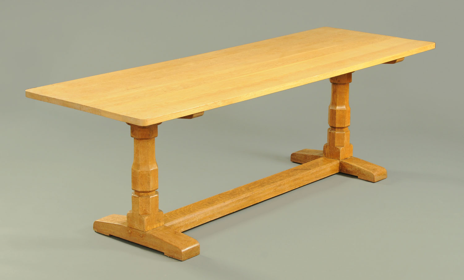 An oak refectory table in the style of Mouseman Thompson of Kilburn, with later top,