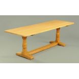 An oak refectory table in the style of Mouseman Thompson of Kilburn, with later top,