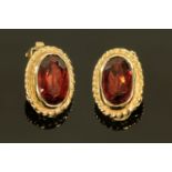 A pair of 9 ct gold garnet ear clips, in Derwent Jewellers box.