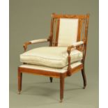 An Edwardian inlaid rosewood low easy chair with loose cushion,