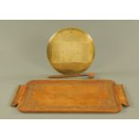 An Islamic brass gong and beater, and a carved hardwood tray.