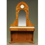 A Victorian Aesthetic Movement hall stand, with aneroid barometer to the arch,