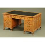 An oak pedestal desk, circa 1930,