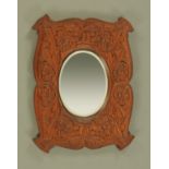 An Arts and Crafts carved oak framed mirror. 59 cm x 45 cm.