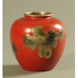 A Japanese lacquered an incised metal vase, decorated with fruiting vines.