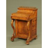 A Victorian walnut piano front Davenport,