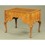 An antique walnut desk, with brown tooled leather writing surface,