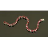 An 18 ct white gold ruby and diamond set bracelet, ruby weight +/- 11 carats, diamonds 1.