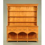 A large pitch pine dresser with Delft rack,