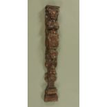 A carved wooden pilaster, putto figures, bellflower and roses. Height 81 cm, width 11.5 cm.