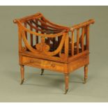 A Victorian rosewood Canterbury, four divisions, with carrying handle and scroll supports,