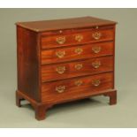 A George III mahogany chest of drawers with brushing slide,