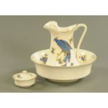 A toilet jug and basin set, circa 1930, decorated with an exotic bird. Bowl diameter 39 cm.