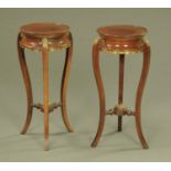 A pair of Regency style mahogany urn stands, with gilt brass mounts. Height 67 cm, diameter 28.