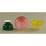 Three Victorian glass lamp shades, cranberry ball shape, green and yellow. Largest diameter 20 cm.