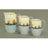 A set of three Grey's pottery style graduated jugs, decorated with galleons against a lustrous sky,