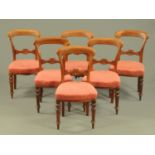 A set of six Victorian mahogany dining chairs, with stuffover seats and raised on turned front legs.