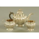 An Indian silver coloured metal three piece tea service, melon shaped,