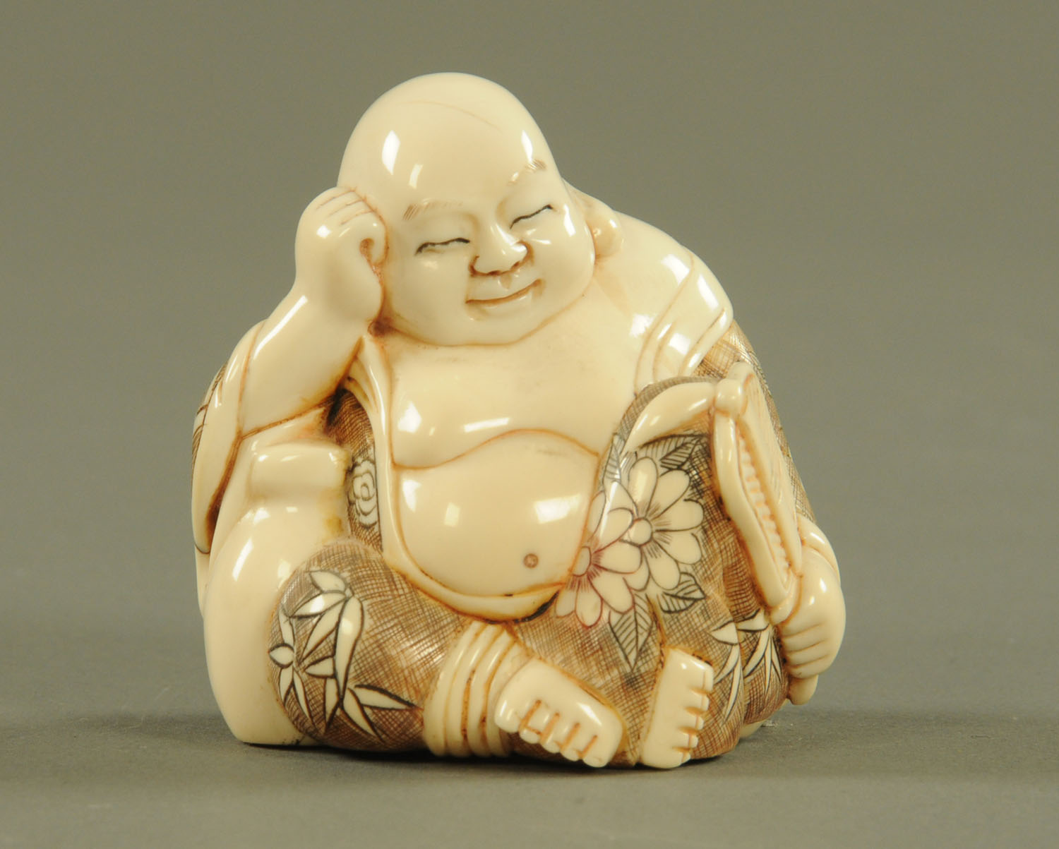 An early 20th century Chinese ivory Buddha, seated, circa 1920, with signature to base.