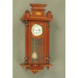 An inlaid mahogany Vienna style wall clock, th three-train ring driven movement.