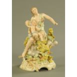 A continental porcelain figure group, lady with cherub on Rococo base. Height 17.5 cm.