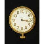 A Swiss made eight day brass car clock, probably from a Model T Ford, knob wind. Diameter 65 mm.