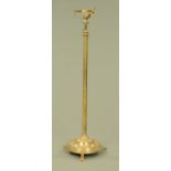 A 19th century brass lamp standard, with circular base raised on three short feet.