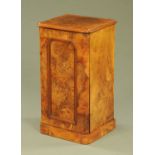 A Victorian walnut bedside cabinet, with single panelled door and plinth base. Width 40 cm.