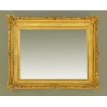 A giltwood and gesso rectangular framed mirror, with foliate moulded outer frame.