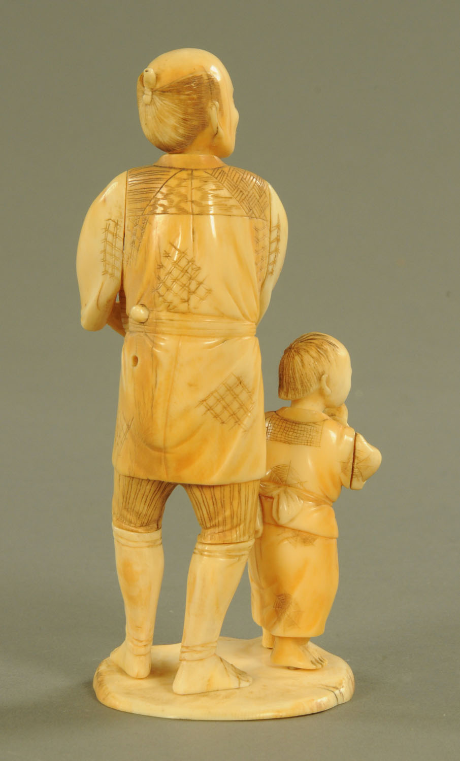 A late 19th/early 20th century Japanese carved ivory figure group, farmer and son, signed to base. - Image 2 of 3