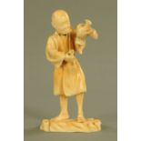 A late 19th/early 20th century Japanese carved ivory figure, male with bird, signed to base.