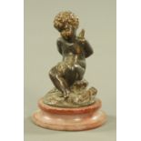 A 19th century bronze Cupid figure, with tied hands and raised on a marble plinth. Height 12 cm.