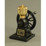 A Birchleaf of London coffee grinder, raised on a wooden stand, height 28 cm.