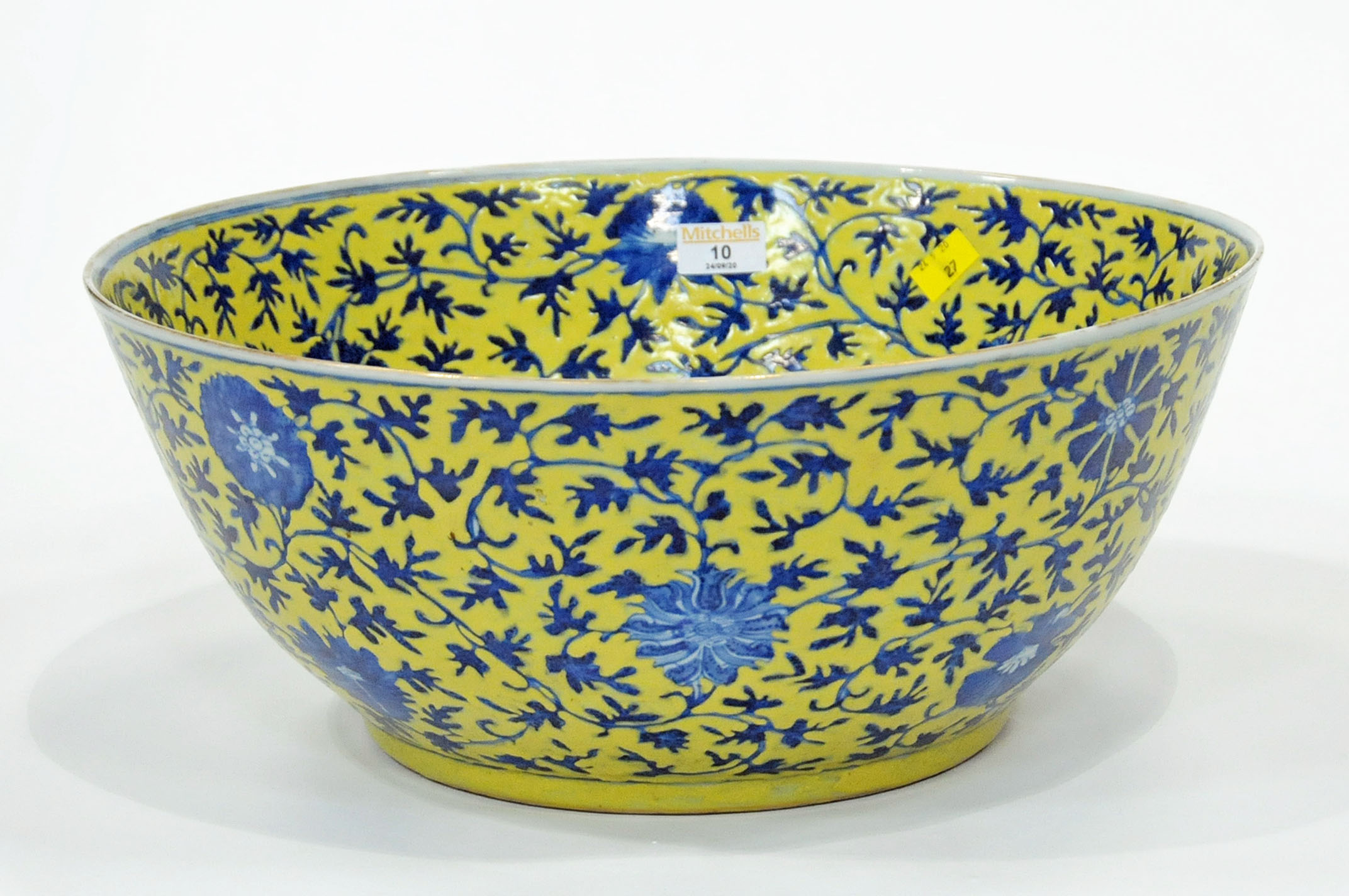 Large blue floral bowl on yellow background,