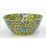 Large blue floral bowl on yellow background,