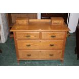 Oak dressing chest with brass drop handles and shaped escutcheons