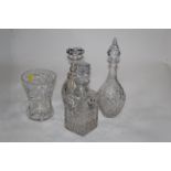 Three glass decanters with stoppers and moulded glass vase