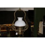 Hanging brass ceiling light with glass shade